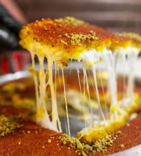 Arabic traditional dessert - kunafa - konafa in a tray with pist